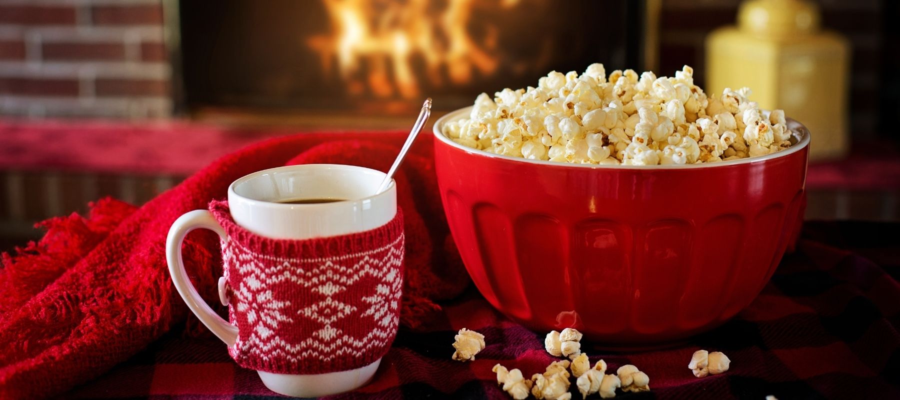 Hot cocoa and popcorn beside a warm fire during the holiday season