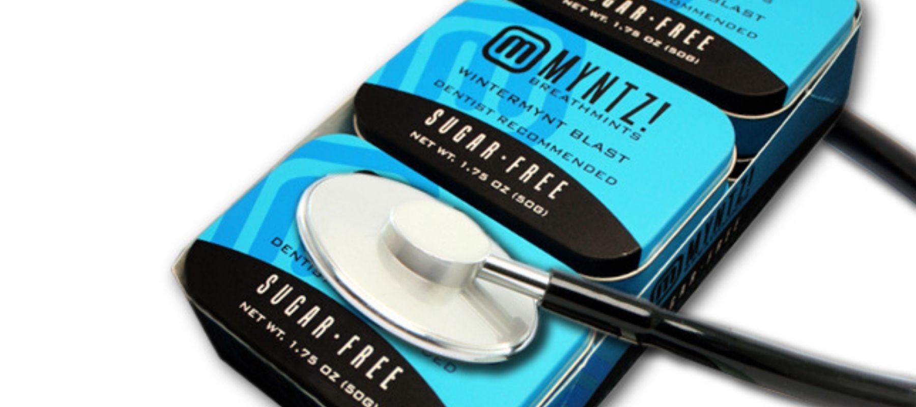 Pack of six tins of WinterMynt Blast with a stethoscope placed on top