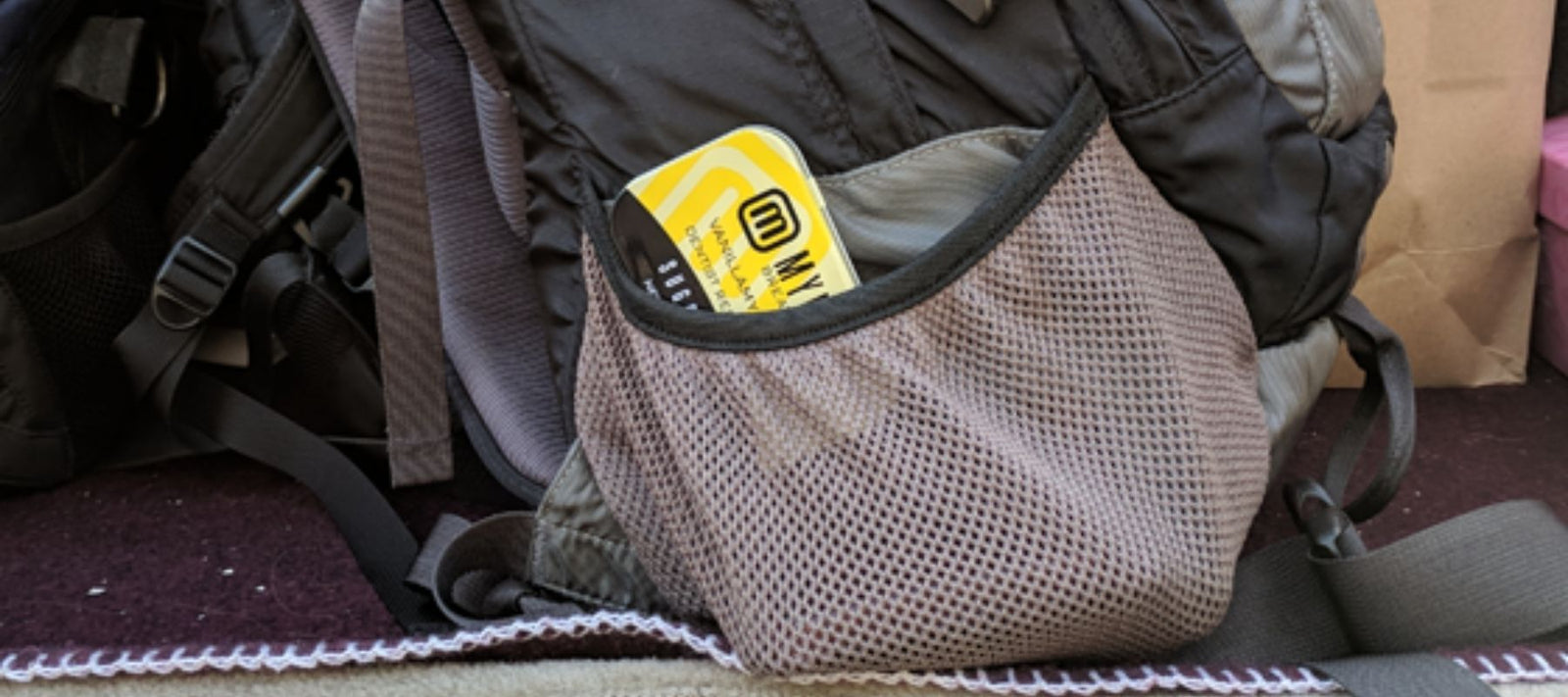 VanillaMynt Blast sticking out of the pocket of a backpack